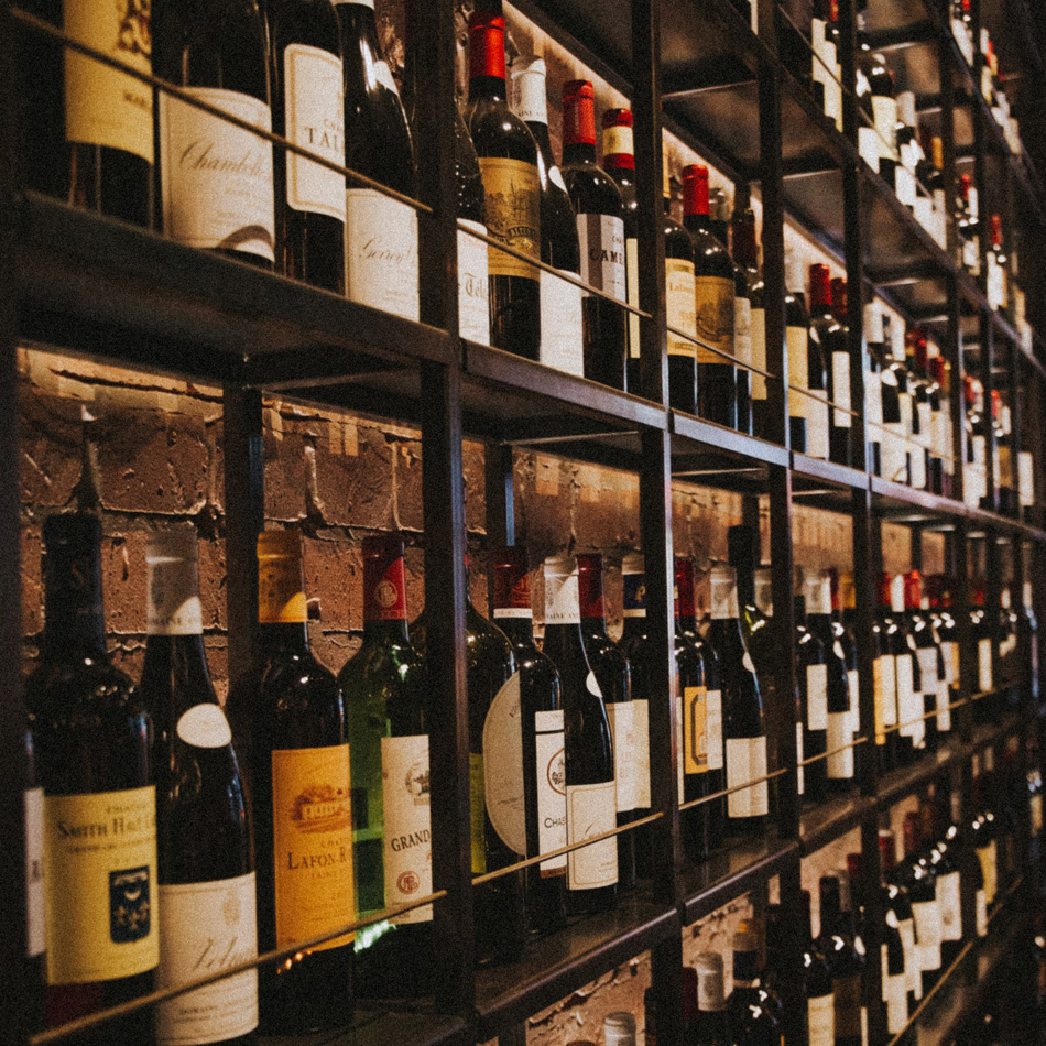 Wine bottles on rack - Photo by Klara Kulikova on Unsplash
